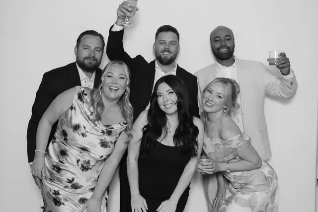 Guests posing for a polished black-and-white Glam Booth portrait, photo 22