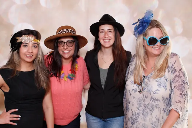 Guests enjoying a photo booth with a champagne backdrop, photo 4