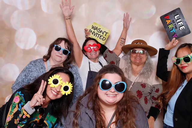 Guests enjoying a photo booth with a champagne backdrop, photo 5