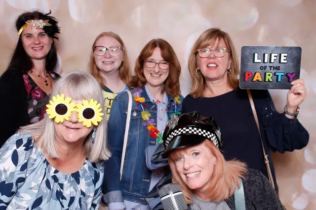 Guests enjoying a photo booth with a champagne backdrop, photo 6