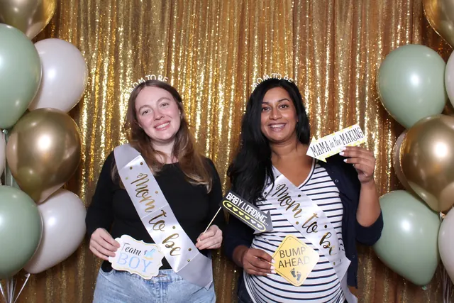 Guests enjoying a photo booth with a gold sequin backdrop, photo 3