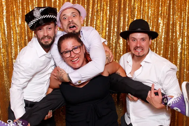 Guests enjoying a photo booth with a gold sequin backdrop, photo 4