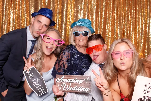 Guests enjoying a photo booth with a gold sequin backdrop, photo 6