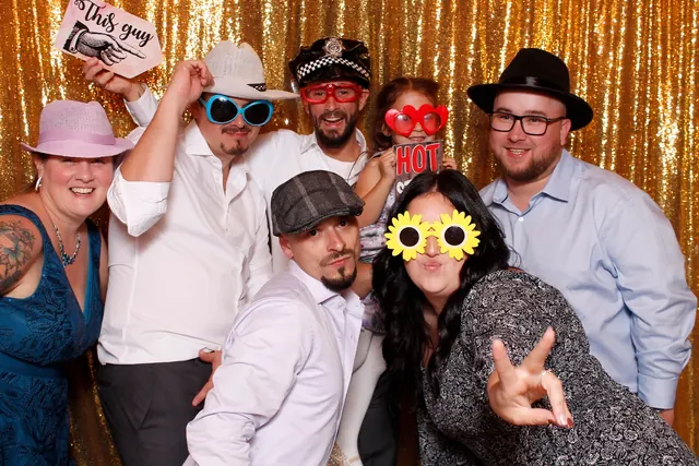 Guests enjoying a photo booth with a gold sequin backdrop, photo 12