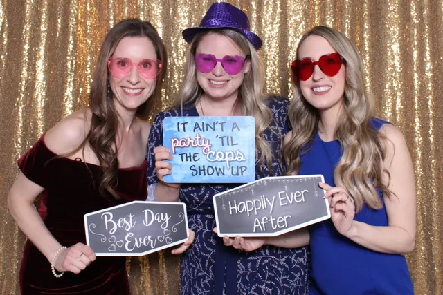 Guests enjoying a photo booth with a gold sequin backdrop, photo 17