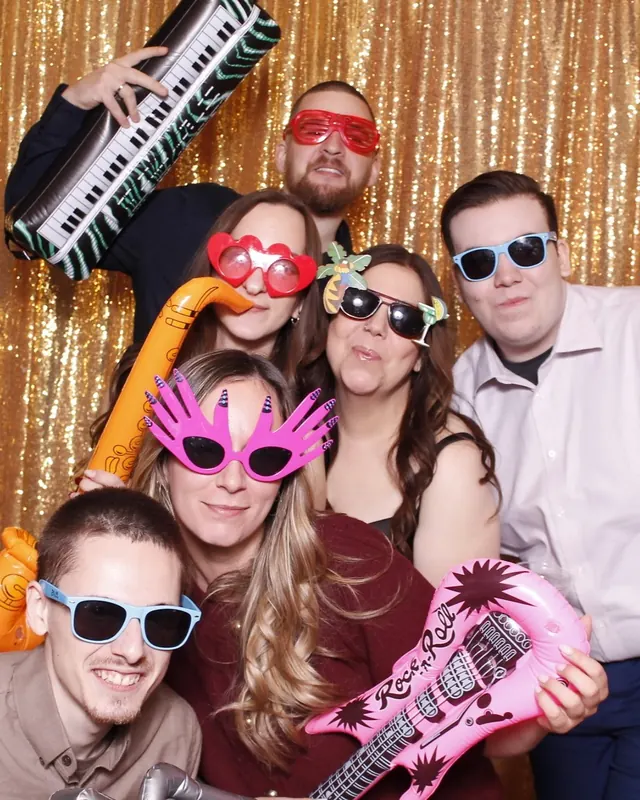 Guests enjoying a photo booth with a gold sequin backdrop, photo 18