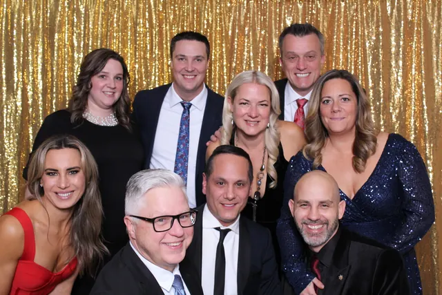 Guests enjoying a photo booth with a gold sequin backdrop, photo 23