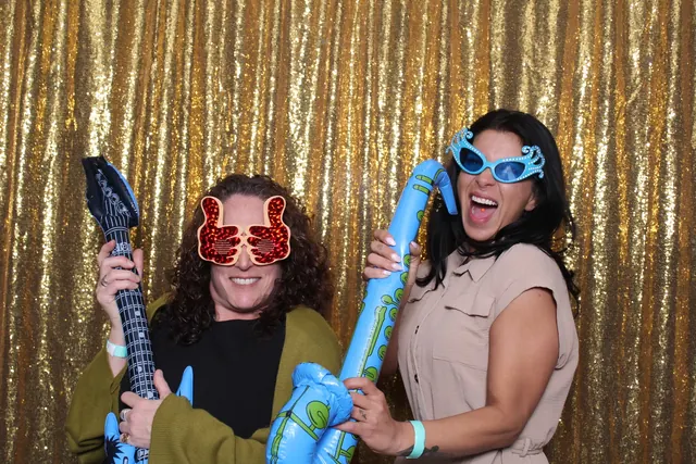 Guests enjoying a photo booth with a gold sequin backdrop, photo 28
