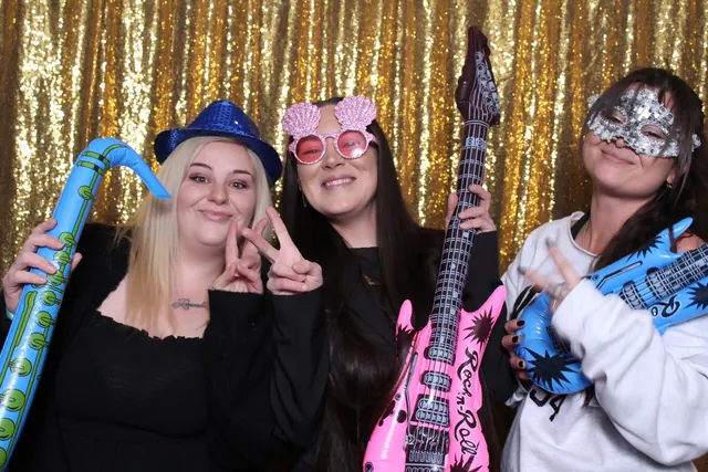 Guests enjoying a photo booth with a gold sequin backdrop, photo 32