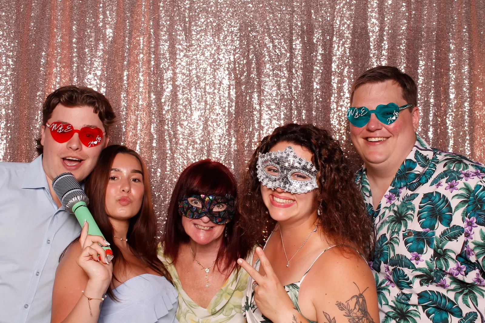 Guests enjoying a photo booth with a rose-gold sequin backdrop, photo 8