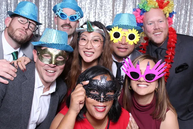 Guests enjoying a photo booth with a silver sequin backdrop, photo 4