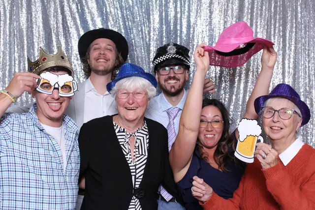 Guests enjoying a photo booth with a silver sequin backdrop, photo 5