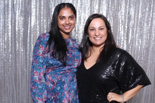 Guests enjoying a photo booth with a silver sequin backdrop, photo 9