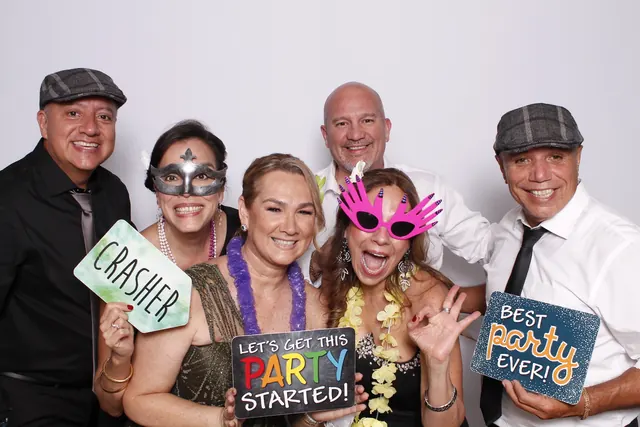 Guests enjoying a photo booth with a white neutral backdrop, photo 3