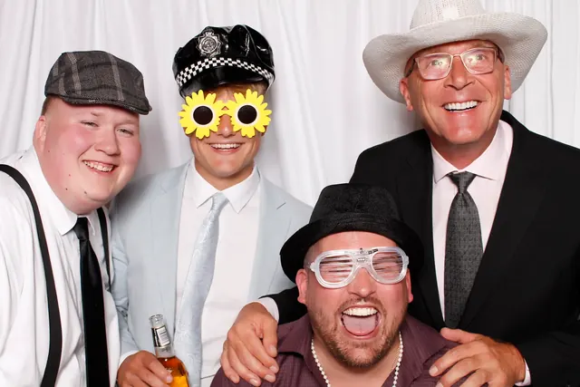 Guests enjoying a photo booth with a white neutral backdrop, photo 5
