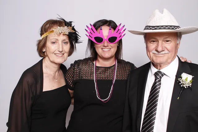 Guests enjoying a photo booth with a white neutral backdrop, photo 6