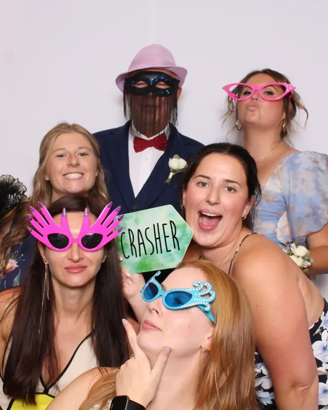 Guests enjoying a photo booth with a white neutral backdrop, photo 36