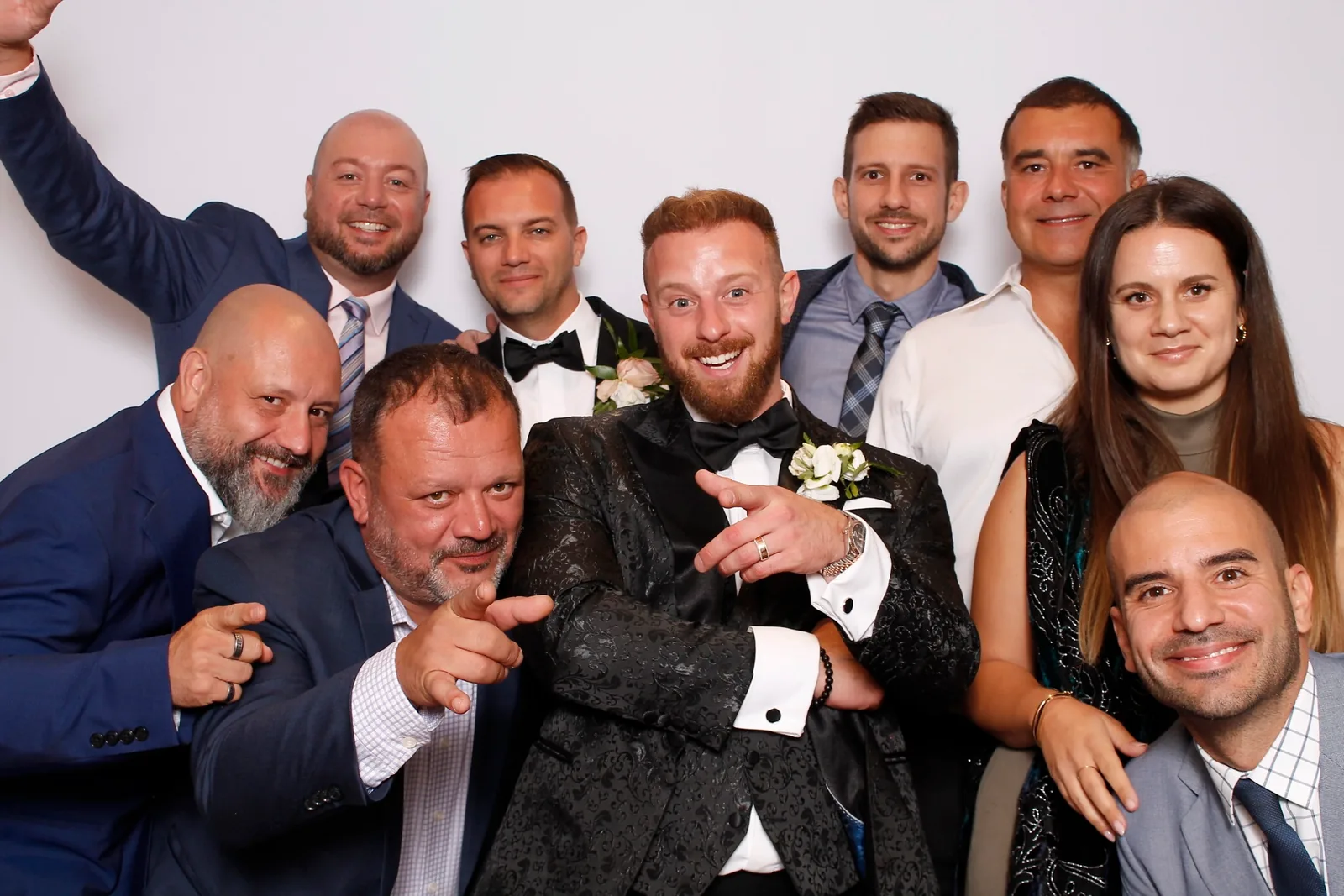 Guests enjoying a photo booth with a white neutral backdrop, photo 38