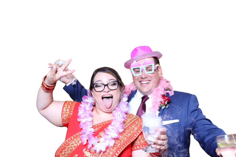 Newlyweds celebrating with colourful photo booth props
