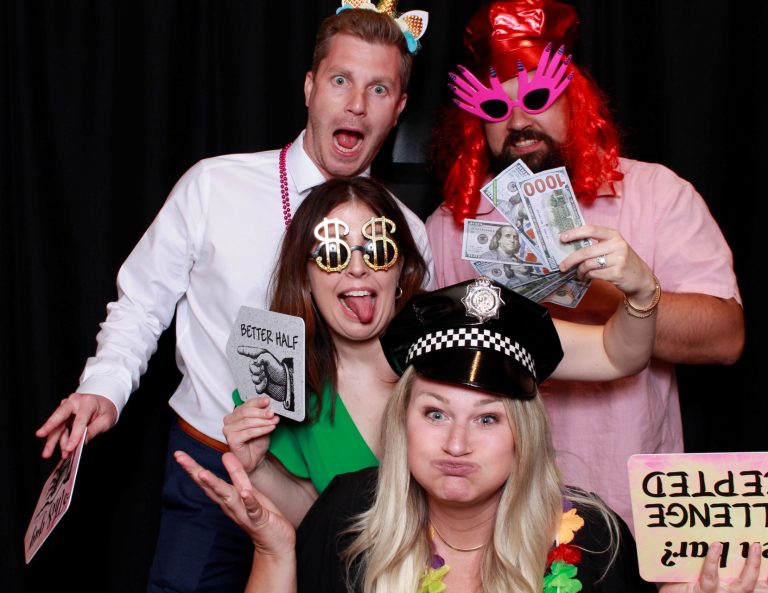 Four guests having fun with colourful photo booth props
